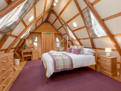 a bedroom with a bed in a attic at Villa Rabbie Burns Lodge by Interhome in Straiton