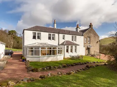 an old house with a conservatory in the yard at Holiday Home Balcraig House by Interhome in Straiton