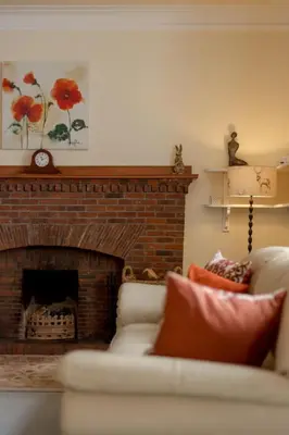 a living room with a couch and a fireplace at Holiday Home Balcraig House by Interhome in Straiton