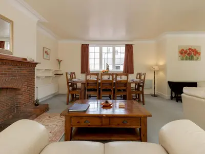 a living room with a table and chairs and a fireplace at Holiday Home Balcraig House by Interhome in Straiton
