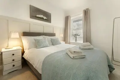 a bedroom with a bed with two towels on it at 6 Harney Peak in Portinscale