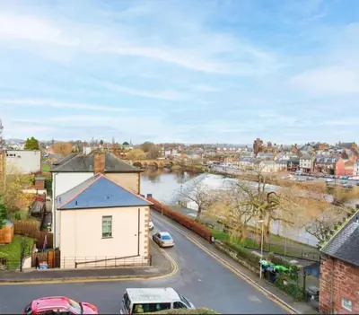 a view of a town with a river and a street at Caul View Apartment in Dumfries in Dumfries