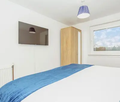 a bedroom with a bed and a window at Caul View Apartment in Dumfries in Dumfries