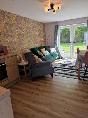 a living room with a couch and a chair at The Burrow by Blake View Holidays a peaceful boutique retreat 3 miles from Ennerdale- standard twin or super-king bed available in Rowrah