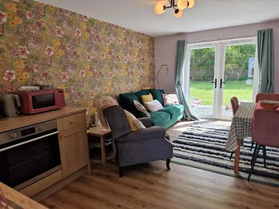 a living room with a couch and a tv at The Burrow by Blake View Holidays a peaceful boutique retreat 3 miles from Ennerdale- standard twin or super-king bed available in Rowrah