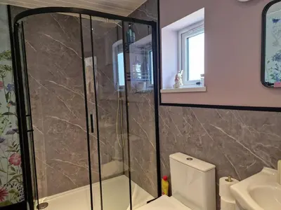 a bathroom with a shower and a toilet and a sink at The Burrow by Blake View Holidays a peaceful boutique retreat 3 miles from Ennerdale- standard twin or super-king bed available in Rowrah
