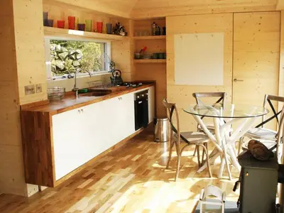 a kitchen with a table and a glass table at Red Kite Eco Bothy - with Hot Tub in Castle Douglas