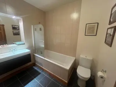 a bathroom with a tub and a toilet and a sink at Cosy Holiday Home Portpatrick in Portpatrick