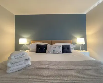 a bedroom with a bed with towels on it at Farmers Retreat in Keswick