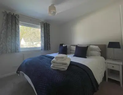 a bedroom with a bed with two towels on it at Farmers Retreat in Keswick