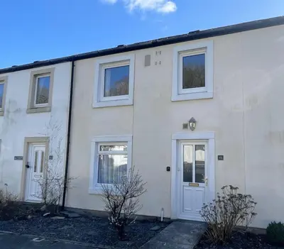 a white house with a white door and windows at Farmers Retreat in Keswick