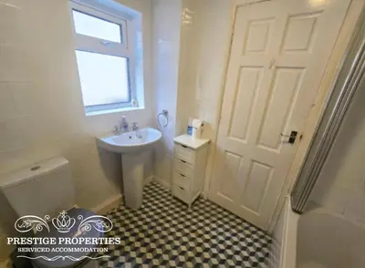 a white bathroom with a sink and a toilet at Harcourt by Prestige Properties SA in Workington