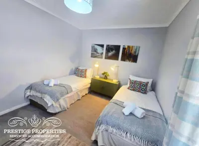 a bedroom with two beds in a room at Harcourt by Prestige Properties SA in Workington