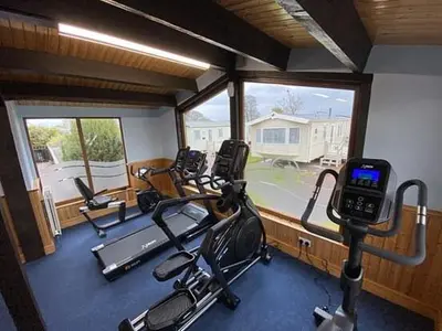 a gym with several exercise bikes and a cell phone at Shelly's Stay in Port Carlisle