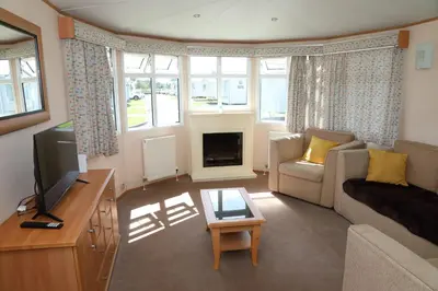 a living room with a couch and a tv at Shelly's Stay in Port Carlisle