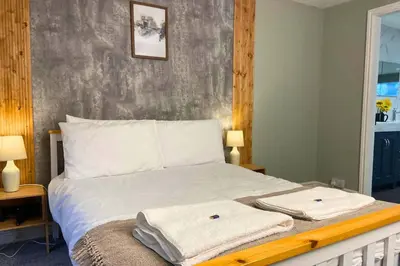 a bedroom with a bed with two towels on it at Secluded Hot Tub, Pool, Escape in Bootle