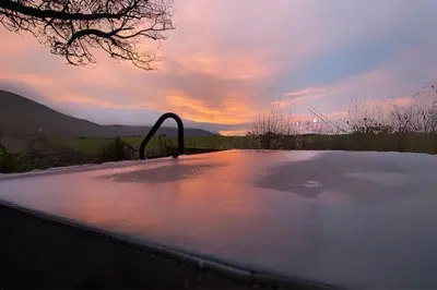 a bath tub with a faucet on top of it at Secluded Hot Tub, Pool, Escape in Bootle