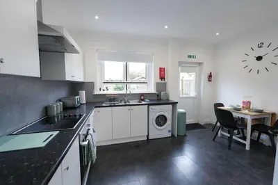 a kitchen with a sink and a washing machine at Barassie Villa located near Troon in Troon