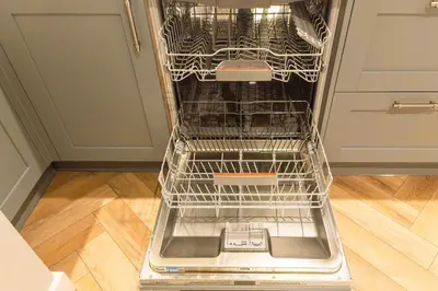 an empty dishwasher with its rack in a kitchen at Stoneyloft Modern Apartment in Glen Vine in Glen Vine
