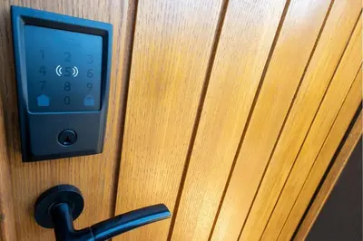 an ipod is plugged into a wooden door at Stoneyloft Modern Apartment in Glen Vine in Glen Vine