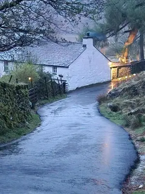 a house on a stream in front of a house at Blea Tarn Farmhouse B&B in Ambleside