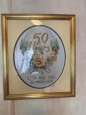 a framed picture of a sign in a gold frame at Grannys Vintage Coastal Caravan in Kippford