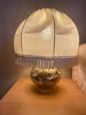 a lamp sitting on top of a table at Grannys Vintage Coastal Caravan in Kippford