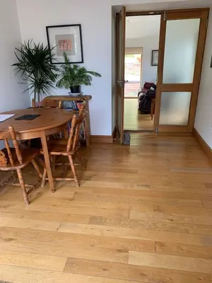 a dining room with a wooden table and chairs at Tan Y Bedw Barn in Moffat