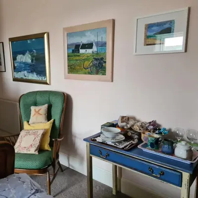 a room with a blue table and a chair at 95 St Mary Street in Kirkcudbright