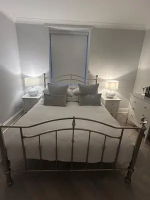 a bedroom with a large bed with two lamps at Stunning 2 bedroom Apartment in Central Keswick in Keswick