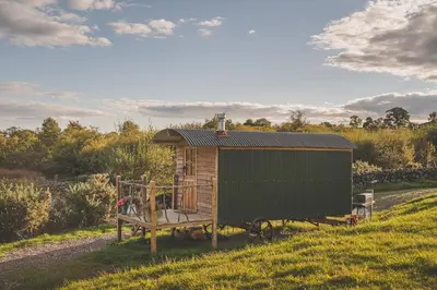 a small shed on the side of a field at Barmoffity Shepherds Hut in Kirkpatrick Durham