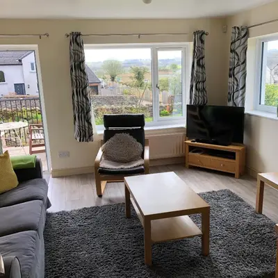 a living room with a couch and a tv at Pottery Cottage - close to the Lake District in Skelton