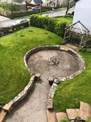 a garden with a fire pit in the grass at Pottery Cottage - close to the Lake District in Skelton