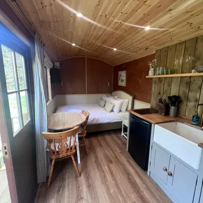 a bedroom with a bed in a tiny house at Mountain View Shepherds Hut in Penrith