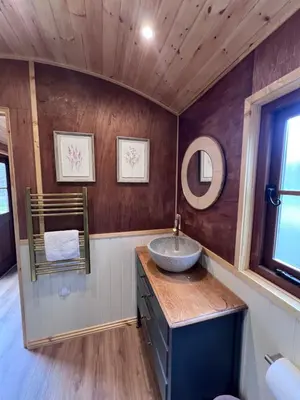a bathroom with a sink and a mirror at Mountain View Shepherds Hut in Penrith