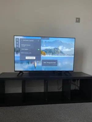 a flat screen tv sitting on a black table at London Holiday Home - 8mins walk from Station Zone 2 in Moffat