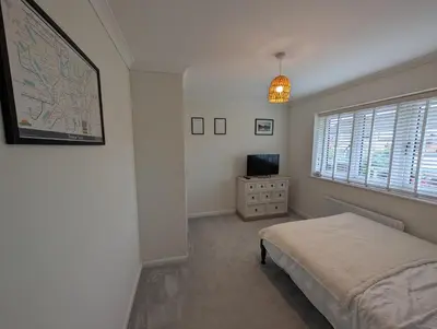 a bedroom with a bed and a tv and a window at 3 Bed-Sleeps 5-Garden-Parking-Pets in Carlisle