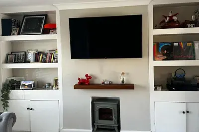 a living room with a tv on a wall with a fireplace at 3 Bed-Sleeps 5-Garden-Parking-Pets in Carlisle