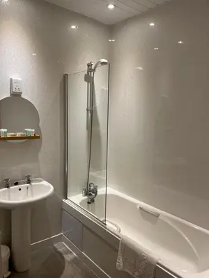 a bathroom with a shower and a sink at The Clachan Inn in Dalry