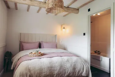 a bedroom with a bed with a basket on it at North Lakes - The Fold Holiday Cottage in Penrith