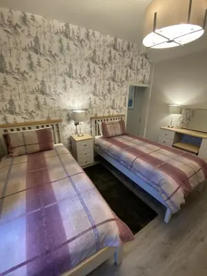 a bedroom with two beds in a room at Tigh-Na-Mara Hotel in Sandhead