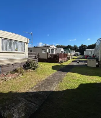 a row of mobile homes in a yard at Creebridge Caravan Park in Newton Stewart