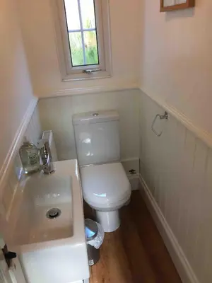 a bathroom with a white toilet and a sink at High House Cottage - A traditional home from home in St Bees