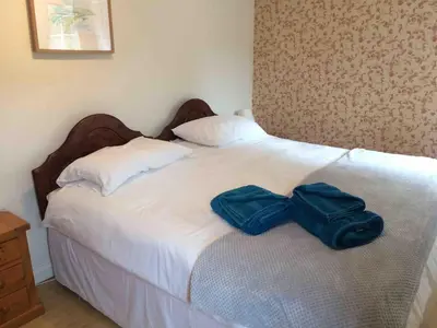 a bed with two bags sitting on top of it at High House Cottage - A traditional home from home in St Bees