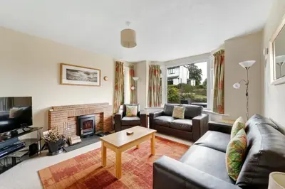 a living room with a couch and a fireplace at Burnmoor in Keswick