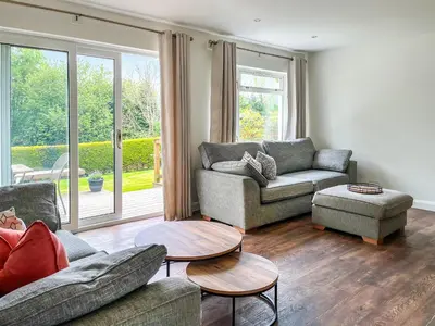 a living room with two couches and a table at Autumn Leaves in Keswick