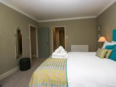 a bedroom with a large bed with towels on it at Osprey Cottage in Ambleside