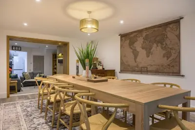a table and chairs in a room with a map on the wall at Moss Crag in Penrith
