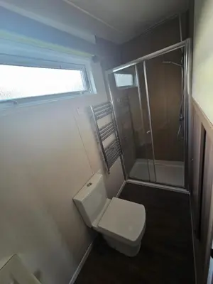 a small bathroom with a toilet and a shower at The View in Ballantrae