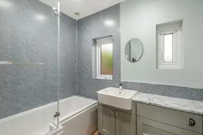 a bathroom with a sink and a tub and a mirror at 3 Bed in Aspatria oc-w31951 in Hayton